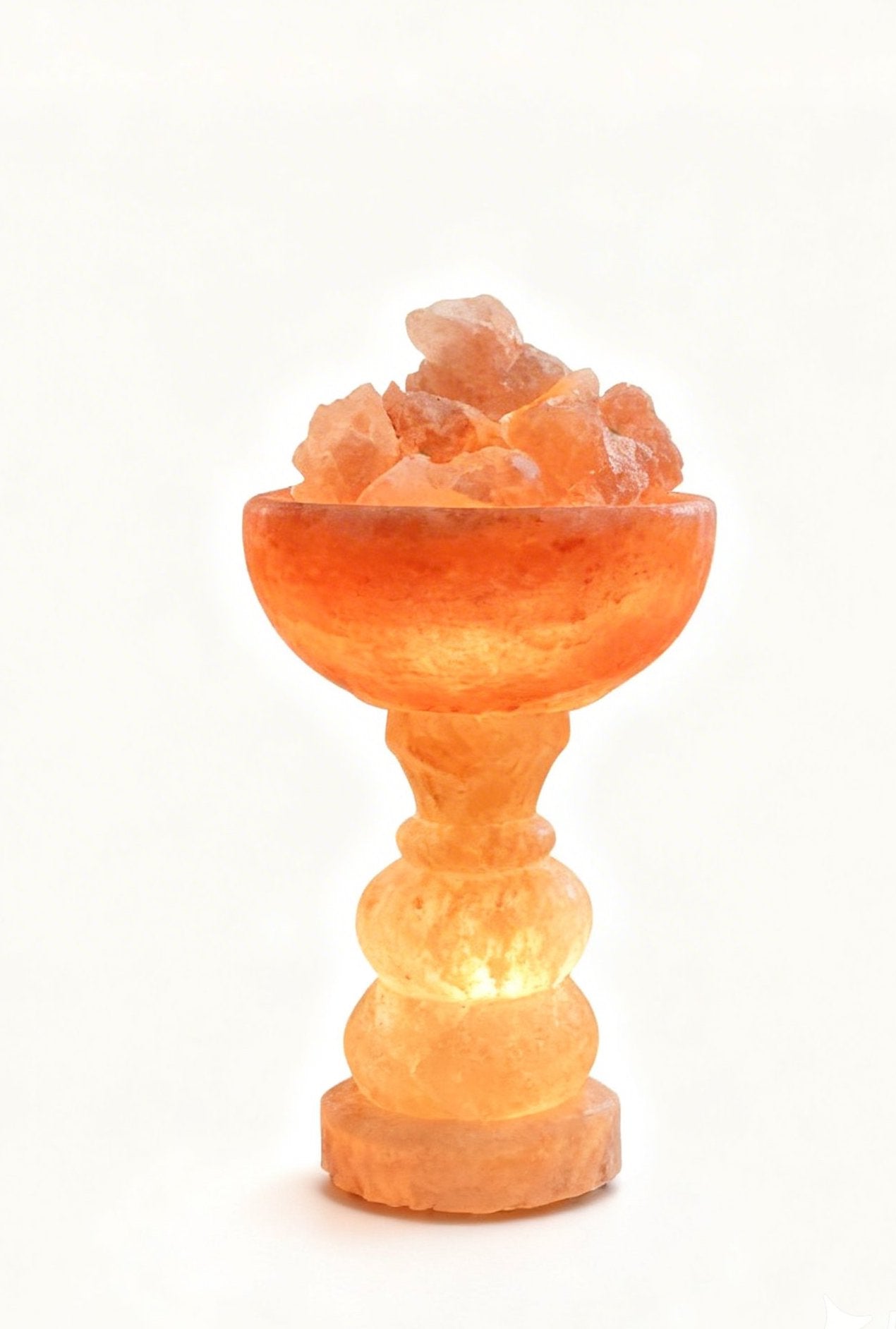 Himalayan pink salt lamp glowing on a table